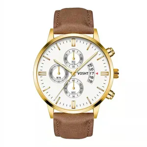 Detail view of gold mens watch dial with three sub-dials and brown leather strap