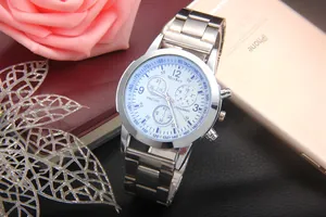 Macro detail of silver stainless steel chronograph watch with blue markers and tachymeter