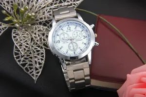 Detailed close-up of a silver stainless steel business watch with a white dial and chronograph