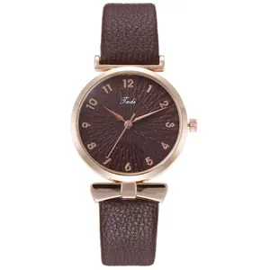 Close-up of elegant women watch with brown leather strap and rose gold metal dial