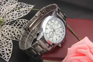 Detail view of men's chronograph watch with silver steel band and tachymeter dial