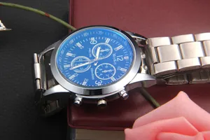 Detail of blue dial business watch featuring three sub-dials and silver stainless steel strap