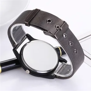 Close-up of black mesh strap and stainless steel case back of a classic quartz watch