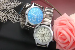 Detail of men's business watches with blue dial and steel strap on decorative background