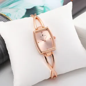 Women's rose gold quartz watch with rectangular sunray dial and X-shaped bangle strap