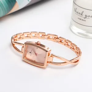 Elegant rose gold rectangular watch with a minimalist sunray dial and a stylish bangle strap