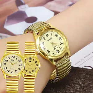 Detail of champagne gold quartz watch with flexible stretch band and Arabic numerals