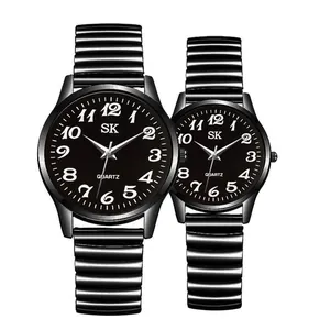 Detail of black quartz couple watches with elastic metal bands and white Arabic numerals