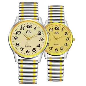 Close-up of couple quartz watches with stretch metal bands and Arabic numeral dials