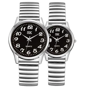 Detail of silver couple watches with black dial and expandable elastic metal band