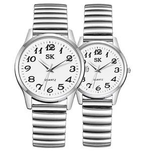 Detail view of couple quartz watches with white dial and stretch metal expansion band