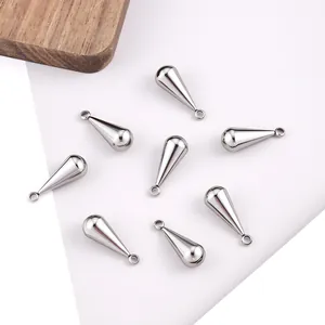 Eight polished stainless steel teardrop pendants for DIY jewelry making on modern background