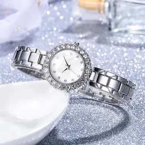 Detail of silver quartz watch featuring crystal bezel and mother-of-pearl dial