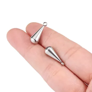 Polished stainless steel water drop pendants held by hand for DIY jewelry making
