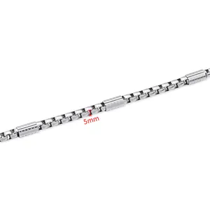 Macro view of 5mm stainless steel box chain with horizontal striped tube accents