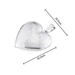 Detailed macro view of 28.5mm heart locket with floral engravings and bail connector