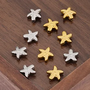 Macro view of gold and silver starfish spacer beads with hole for jewelry making