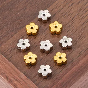 Macro detail of 18K gold and silver 3D flower spacer beads for DIY jewelry making