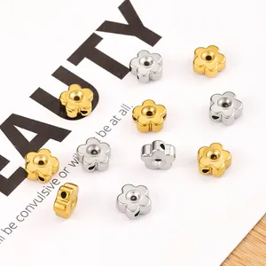 Macro shot of 18K gold and silver plated stainless steel 3D flower beads for DIY jewelry