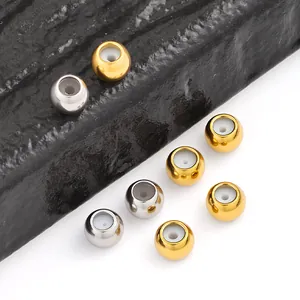 Macro detail of gold and silver vacuum plated stainless steel sliding beads with silicone core