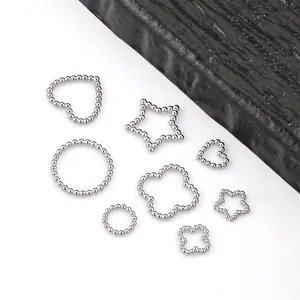 Detailed view of silver stainless steel beaded charms in clover, heart, and star shapes