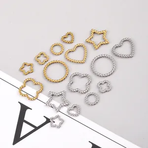 Assorted gold and silver stainless steel charms in heart star and clover shapes for DIY jewelry