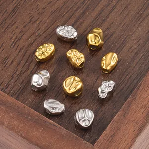 Macro shot of irregular baroque style gold and silver stainless steel beads for DIY jewelry