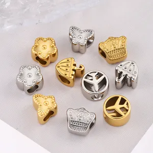 Macro shot of gold and silver charms featuring floral, crown, and airplane DIY designs