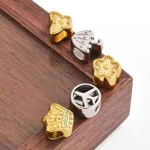 Macro shot of stainless steel charms with butterfly and crown designs for jewelry making