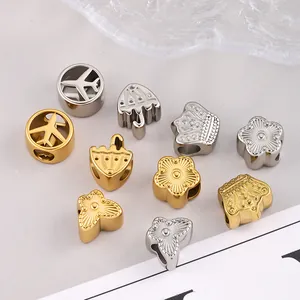 Gold and silver stainless steel charms featuring plane, crown, and flower for DIY jewelry