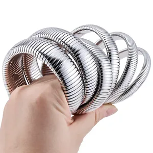 Close-up of flexible silver stainless steel spring snake bracelets on hand