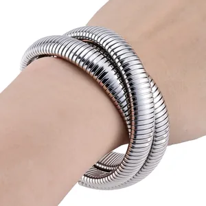 Macro shot of silver snake bone flexible bangle with industrial grooved texture