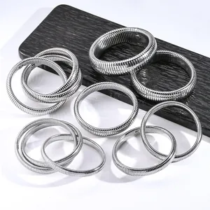 Detail of high-polished silver stainless steel elastic snake bone bracelets with vertical texture