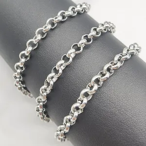 Macro shot of polished silver stainless steel rolo chain on black leather display