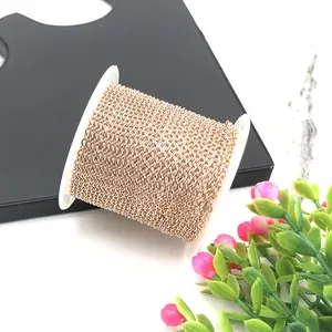 Detail of rose gold plated stainless steel O-chain wound on a white plastic spool