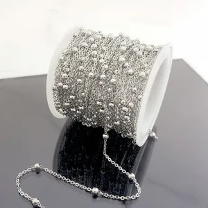 Silver stainless steel bead chain on white spool roll for DIY jewelry making supplies