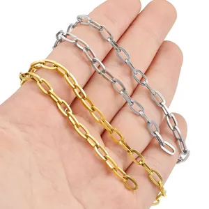 Polished gold and silver stainless steel oval link chains shown on hand for scale