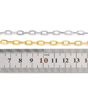 Detailed view of 4mm gold and silver oval link chains with ruler for size reference