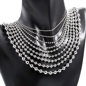 Detailed comparison of various sizes of polished silver beaded chains on a black mannequin