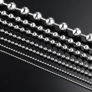 Macro shot of polished stainless steel ball chains in various sizes on black background