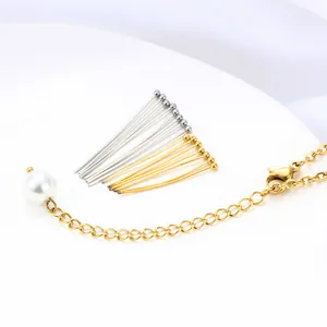 Detailed view of gold ball head pins and pearl extension chain for DIY jewelry making