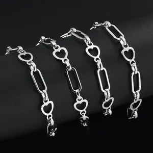 Polished silver stainless steel heart and paperclip link chains displayed on a black stand