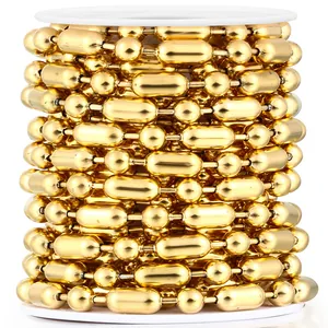 Detailed view of golden ball and barrel bead chain spool for DIY jewelry crafts