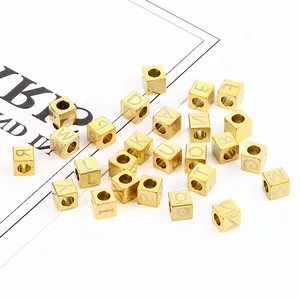 Detailed macro view of gold-plated square alphabet beads for DIY jewelry making