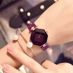 Close-up of elegant purple octagonal watch paired with pearl and diamond bracelets