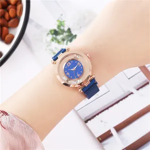 Women's rose gold watch with blue dial, floating crystals, and magnetic mesh band