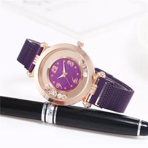 Detail of purple glitter dial watch with rose gold case and crystal decoration