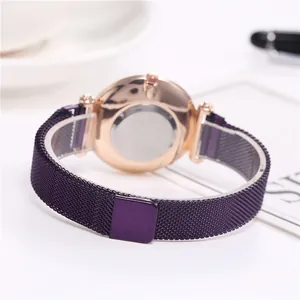 Close-up of purple mesh watch strap and rose gold case with polished steel back