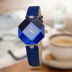 Detail of blue leather strap with rose gold casing and geometric cut glass watch face