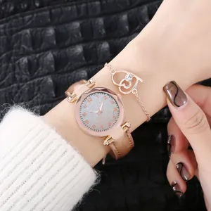Close-up of rose gold watch with silver glitter dial and matching double heart bracelet